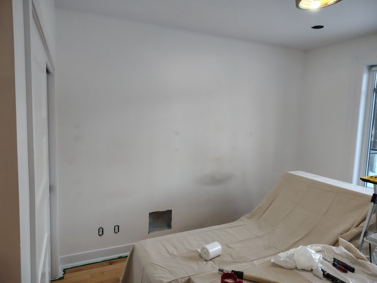 A light-coloured wall before it was painted lilac